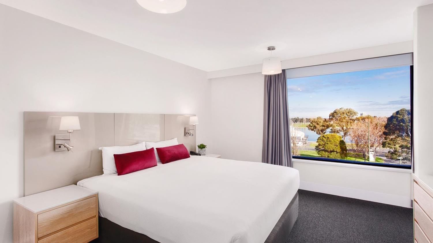 King bed by side desk in Mercure Superior One-Bedroom Lakeview Suite at Pullman Albert Park