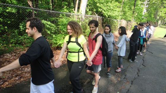 Guests holding hands & walking at Honor's Haven Retreat