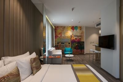 Living room & bedroom in Deluxe Studio Room at Eastin Residences Vadodara
