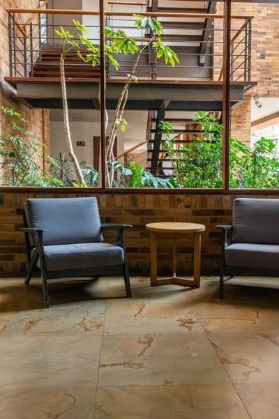 Hotels in Bogota, with cozy seating area with two armchairs and a small table in the common area at Habitel Hotel Select