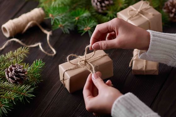 Close-up of hands wrapping Christmas gifts at The Danna Langkawi