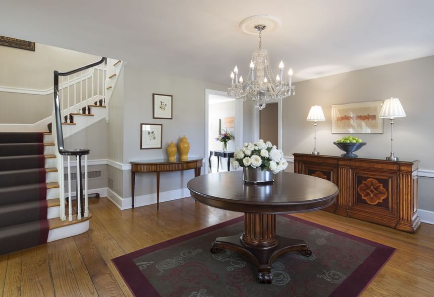Laurie House elegant foyer with crystal chandeli, and curved staircase at Aramark Chauncey Conference Center