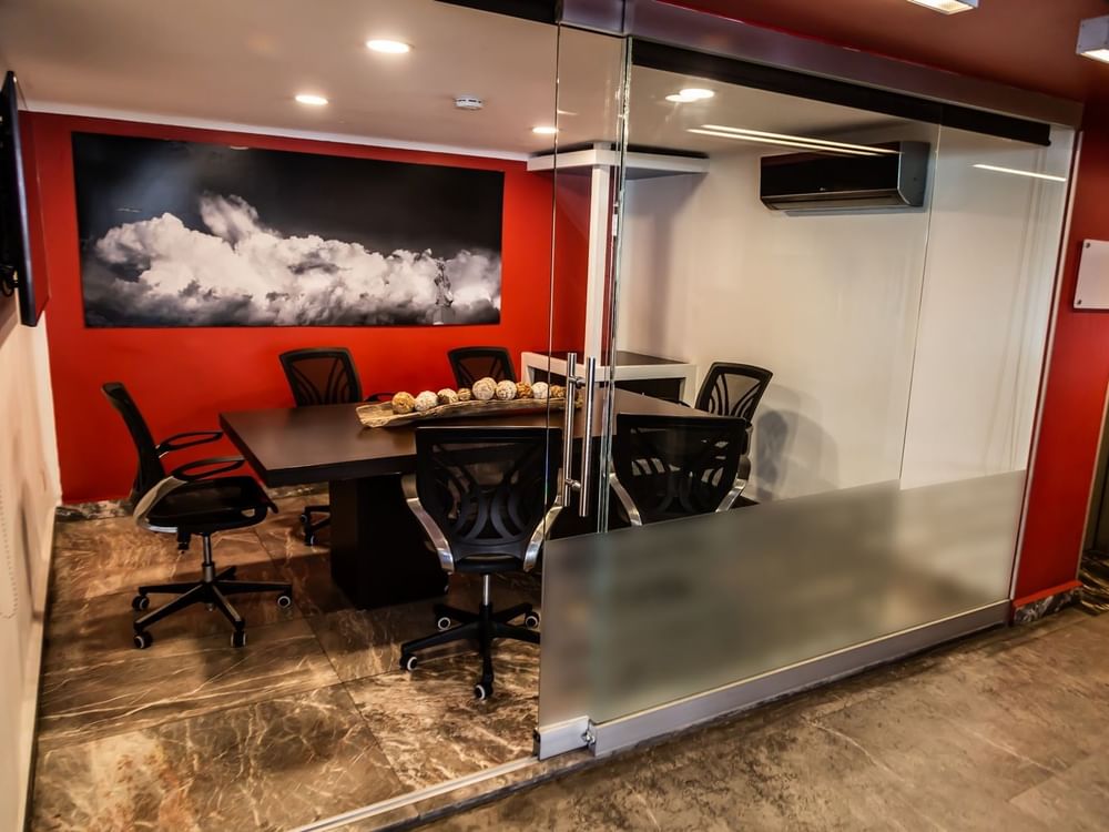 Meeting room set up with wall art & TV in a Business Center at Gamma Puebla Señorial Centro