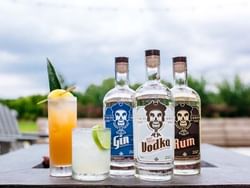 Bottles of Nauti spirits with cocktails at ICONA Avalon Resort
