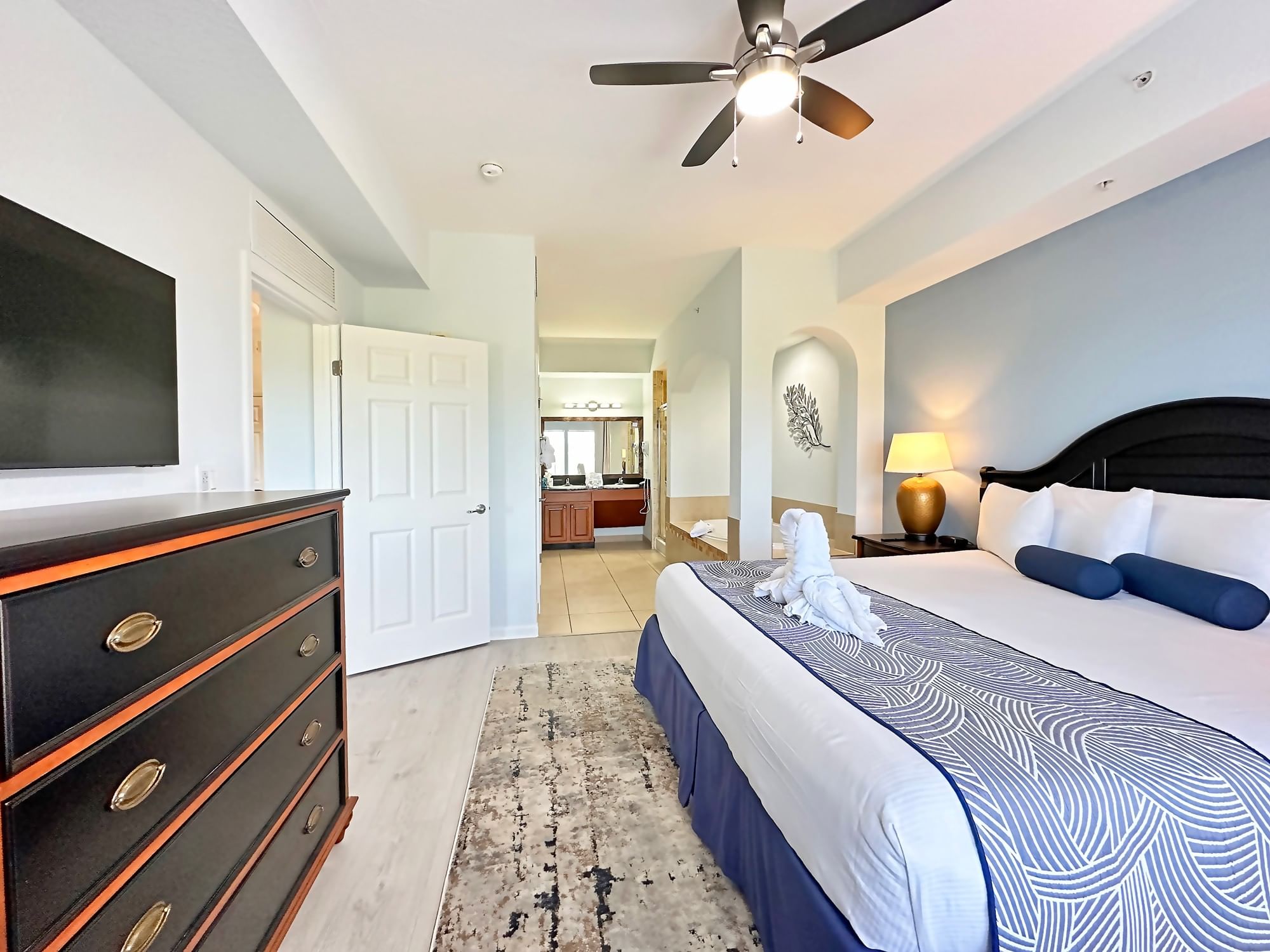 LBV Signature Collection Suite - Primary Bedroom with Tile Flooring, Flat Screen TV, and Master Bath