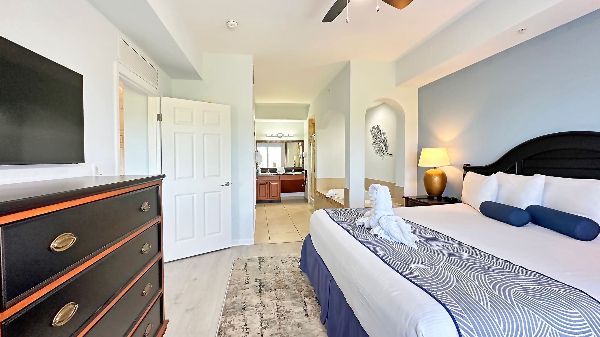 LBV Signature Collection Suite - Primary Bedroom with Tile Flooring, Flat Screen TV, and Master Bath