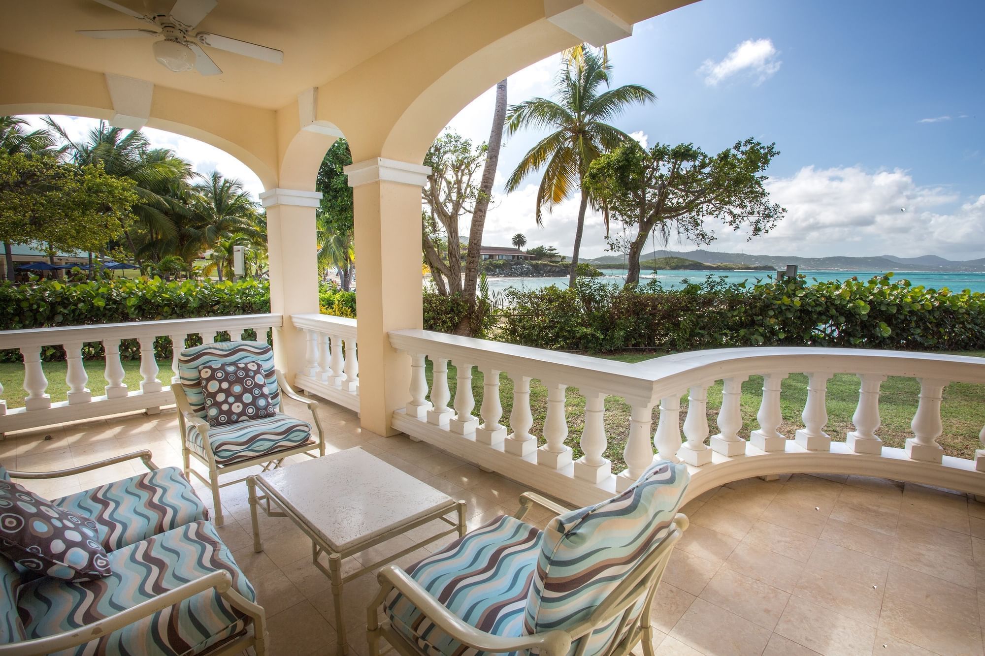 Lounge area in a Suite balcony with sea view at The Buccaneer Resort St. Croix
