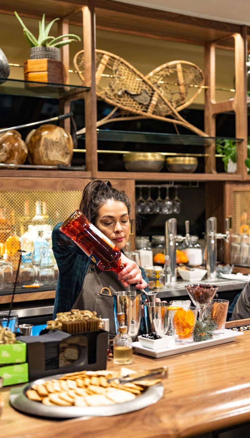 Bartender pouring liquor at José Restaurant bar at Elevation Resort Spa 