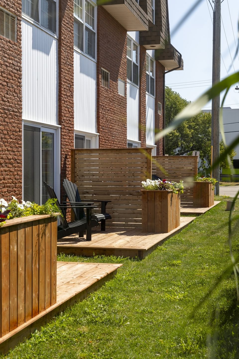 Private patio with Adirondack chairs in outside, relaxing choice among places to stay in Charlottetown, PEI, at Rodd Royalty