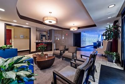 Comfy chairs in the lobby area at Artmore Hotel