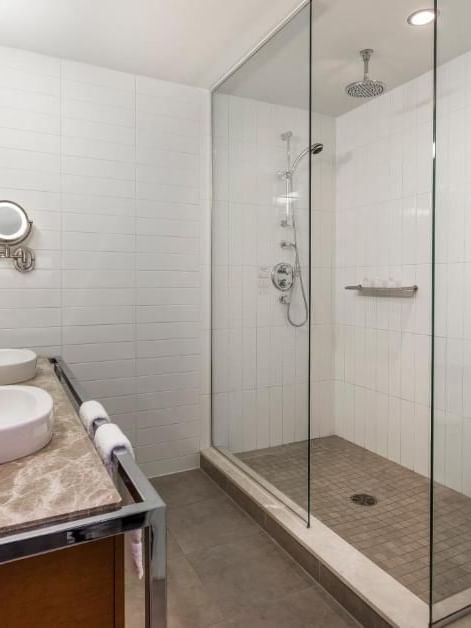 Bathroom with shower and sink in Junior balcony suite at Warwick Le Crystal Montreal