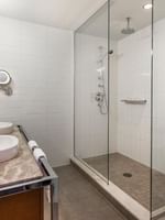 Bathroom with shower and sink in Junior balcony suite at Warwick Le Crystal Montreal