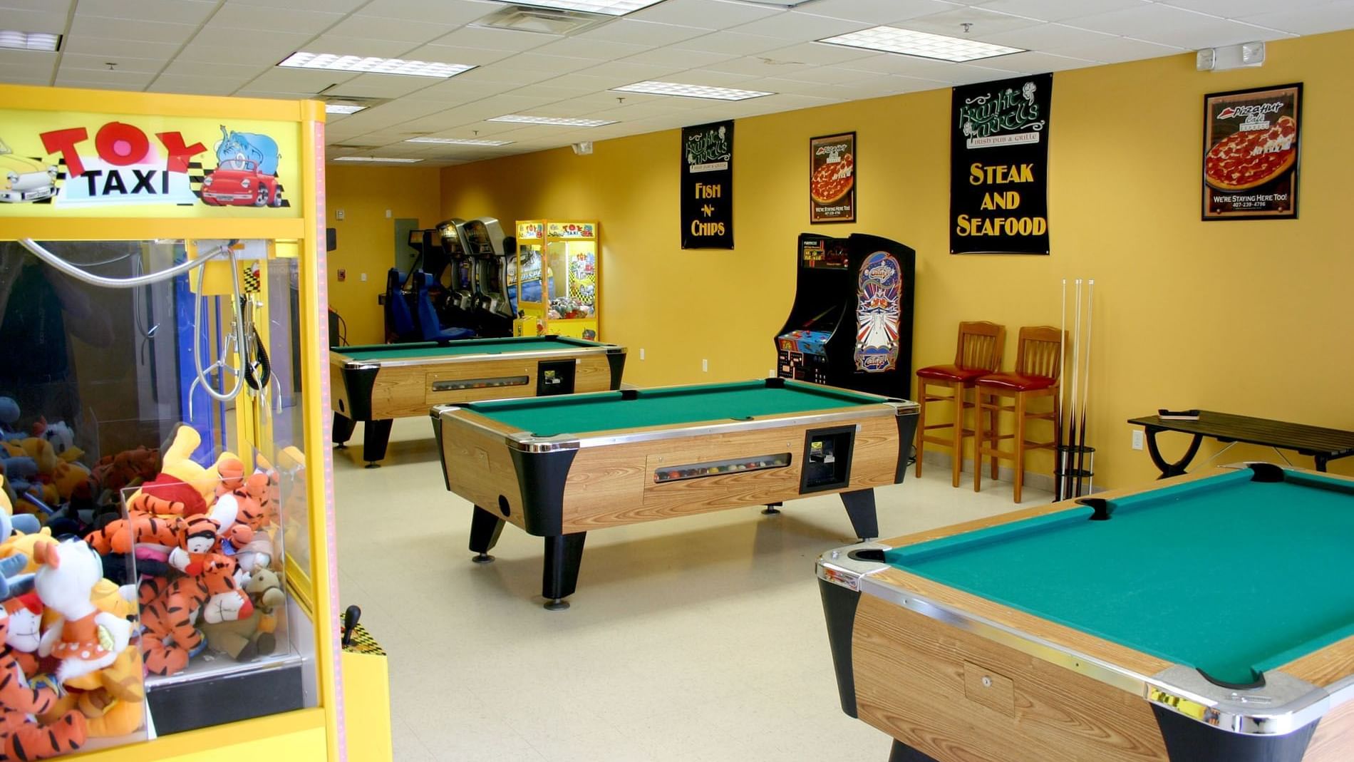 Game room with pool table and arcade games at Lake Buena Vista Resort Village & Spa