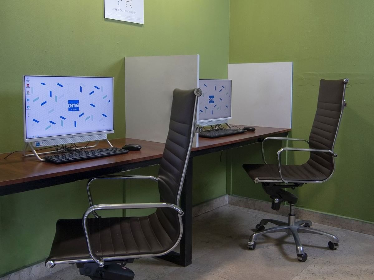 Business Center with computers & chairs at One Hotels