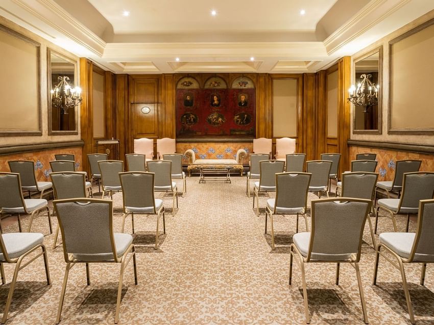 Salon Torre Ejecutiva theater-style seating in a classic room with historic art and wood accents at Quinta Real Monterrey