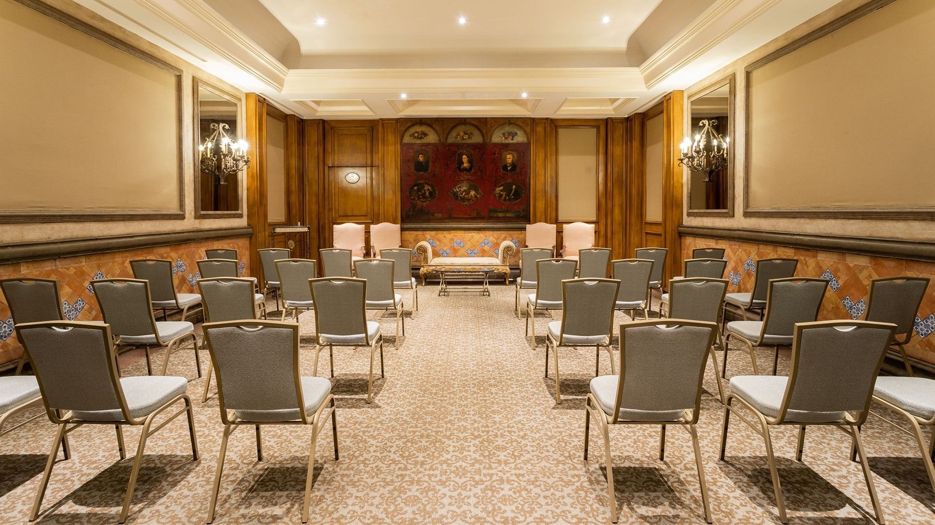 Salon Torre Ejecutiva theater-style seating in a classic room with historic art and wood accents at Quinta Real Monterrey