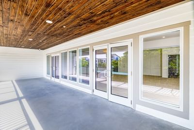 Balcony with white doors and wood ceiling at Grant Street Inn in Dunedin FL