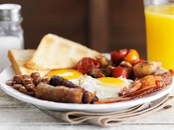 Classic full English breakfast with eggs, bacon, sausage, and toast in Apropos Restaurant & Bar at The Abbey Inn & Spa