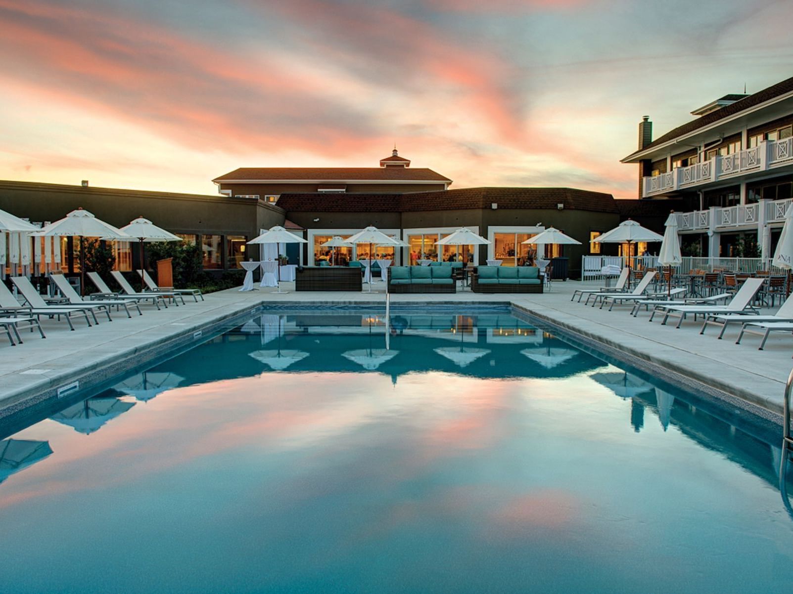 Pool with lounge chairs at our NJ shore hotel at sunset