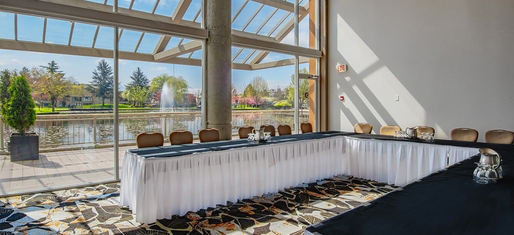 Chilliwack Fraser Room meeting space with floor-to-ceiling windows overlooking the park fountain.
