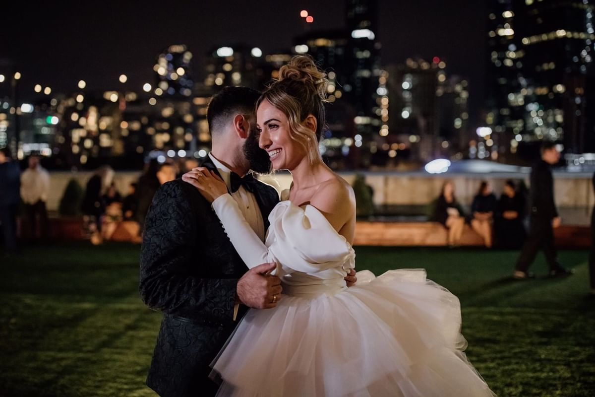 Wedded couple dancing with city views at Crown Hotel Melbourne