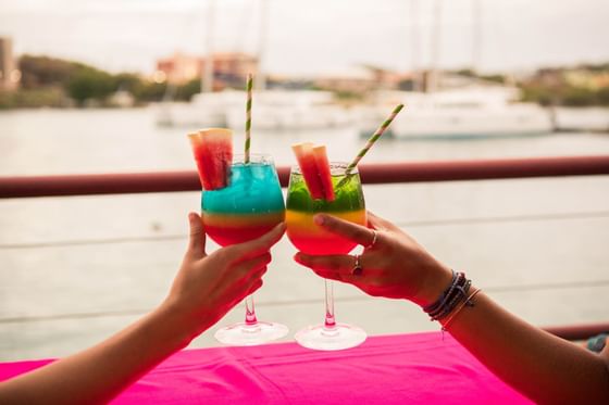 Closeup of toasting cocktails at True Blue Bay Hotel