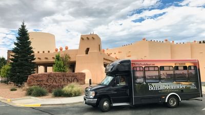 Buffalo Thunder Casino shuttle bus parked outside the beautiful Hilton Santa Fe Buffalo Thunder