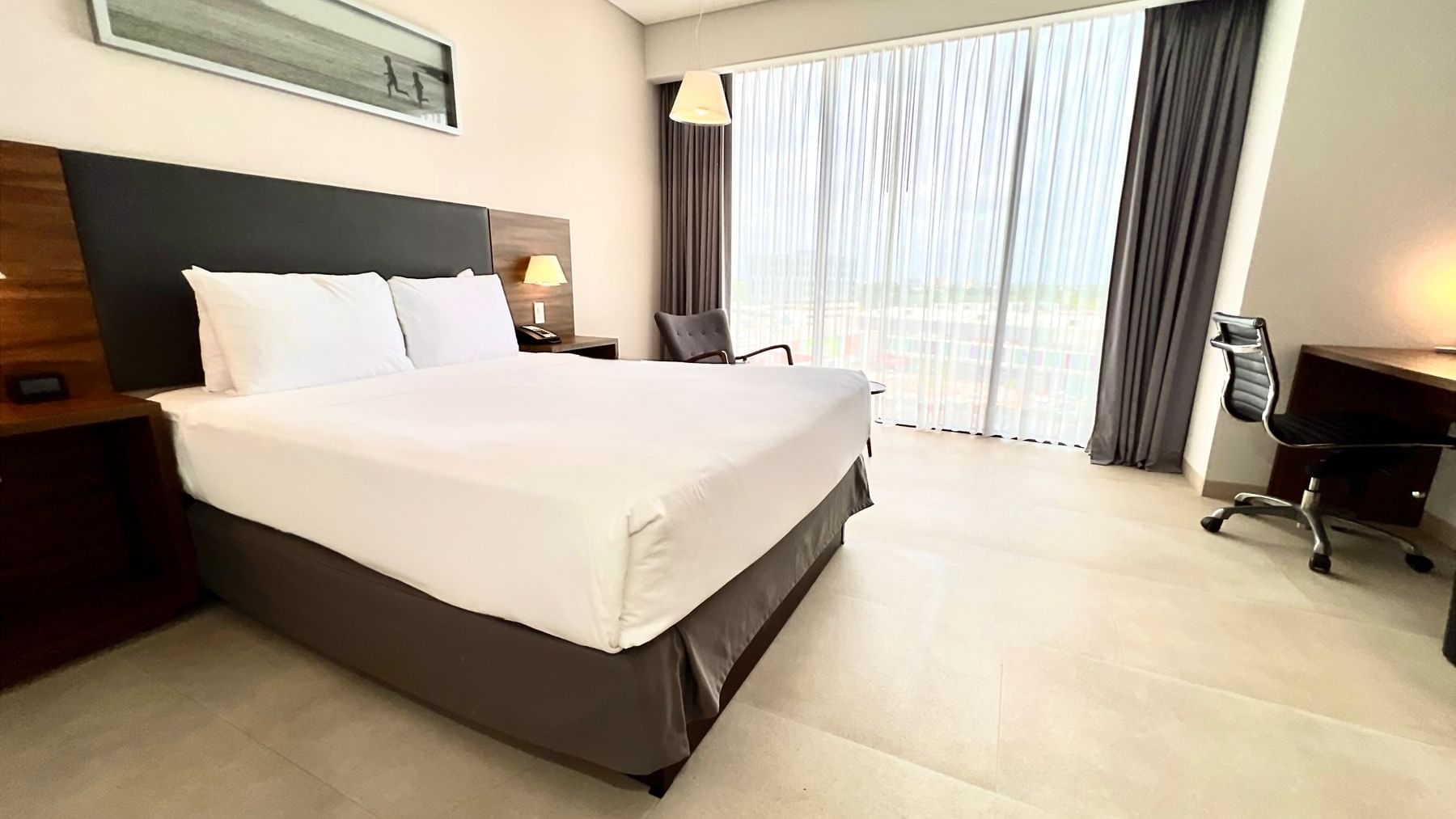 Superior Room at Fiesta Inn Express Cancún Cumbres, featuring a bed & picture over the headboard, where to stay in Cancun