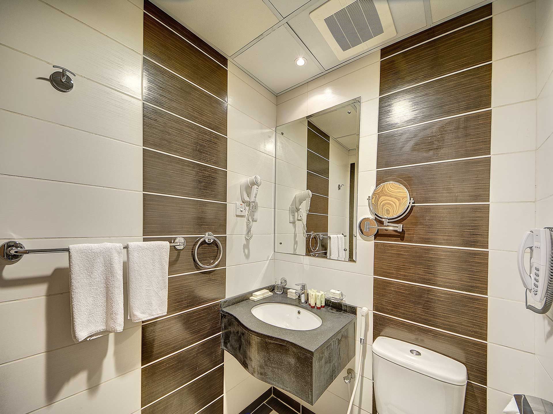 Bathroom vanity area in Triple Room at Elaf Bakkah Hotel