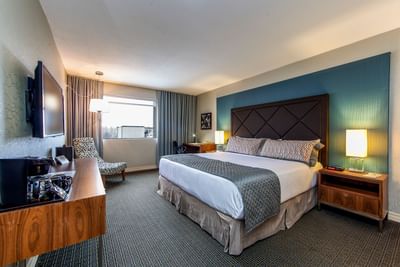King bed with wall mounted TV.