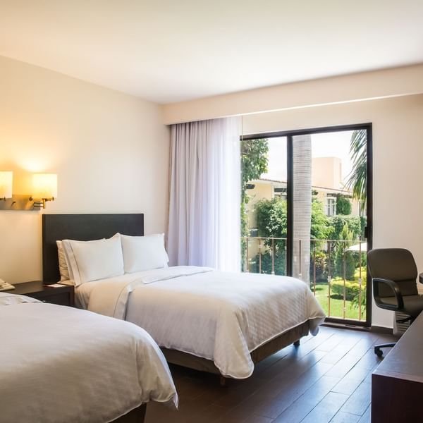Twin beds with working desk in Superior Room at Fiesta Inn