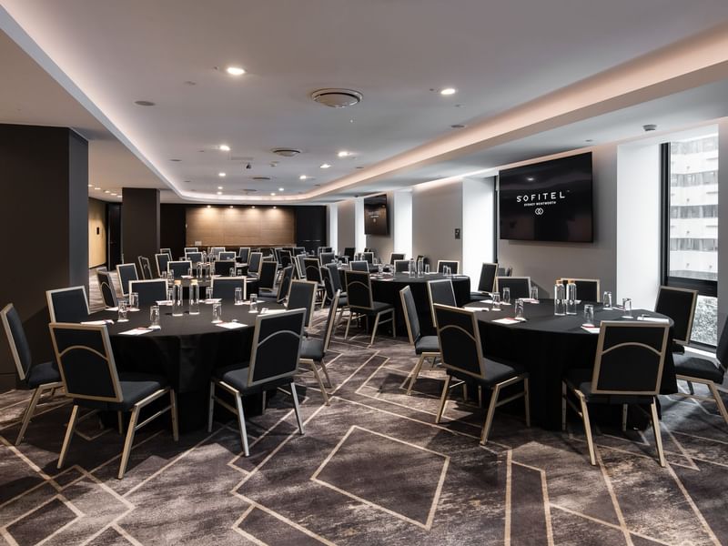 Adelaide room event venue configured for group dining with multiple round table arrangements