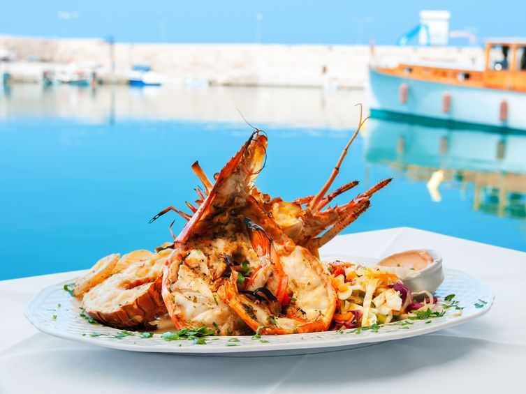 A lobster dish served by the pool at Grand Coloane Resort
