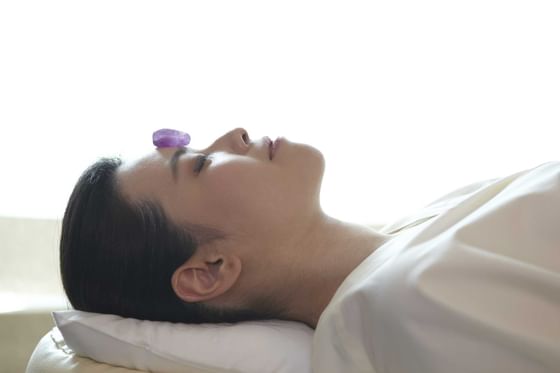 Lady relaxing on a spa bed at Okura Prestige Bangkok