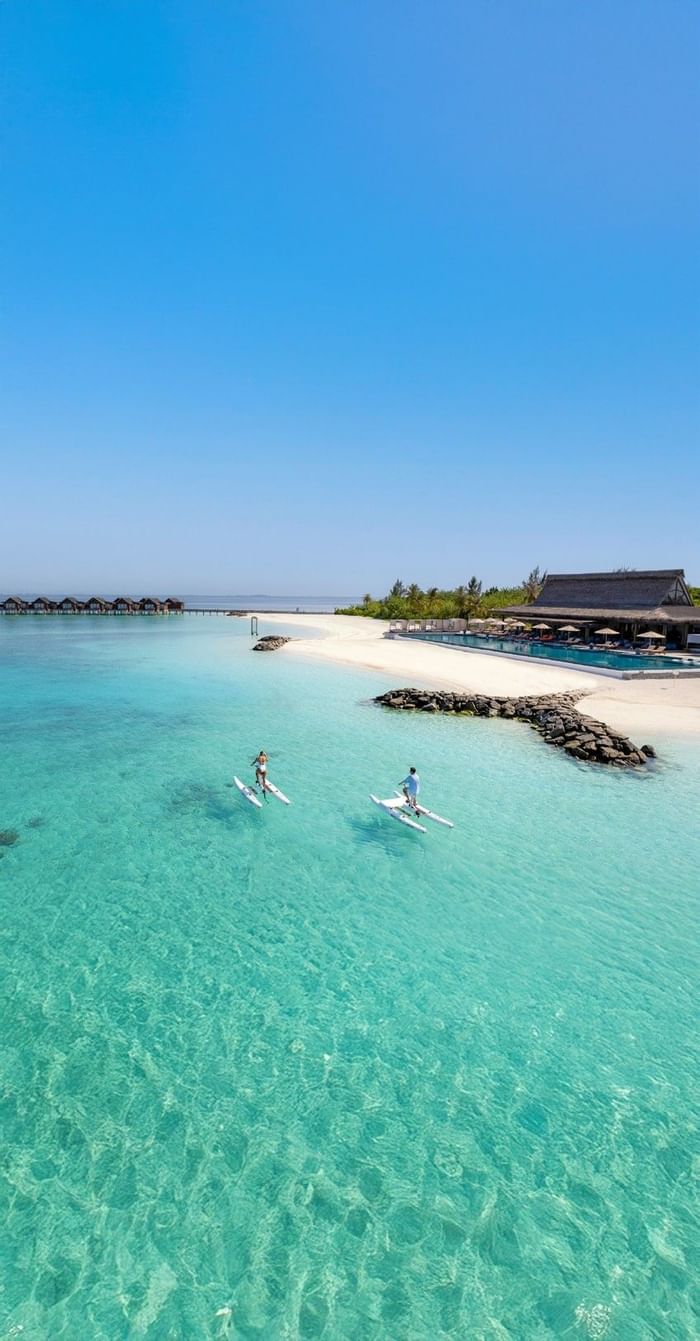 Aerial view of two people on water bike near the beach in the blue ocean at Grand Park Kodhipparu