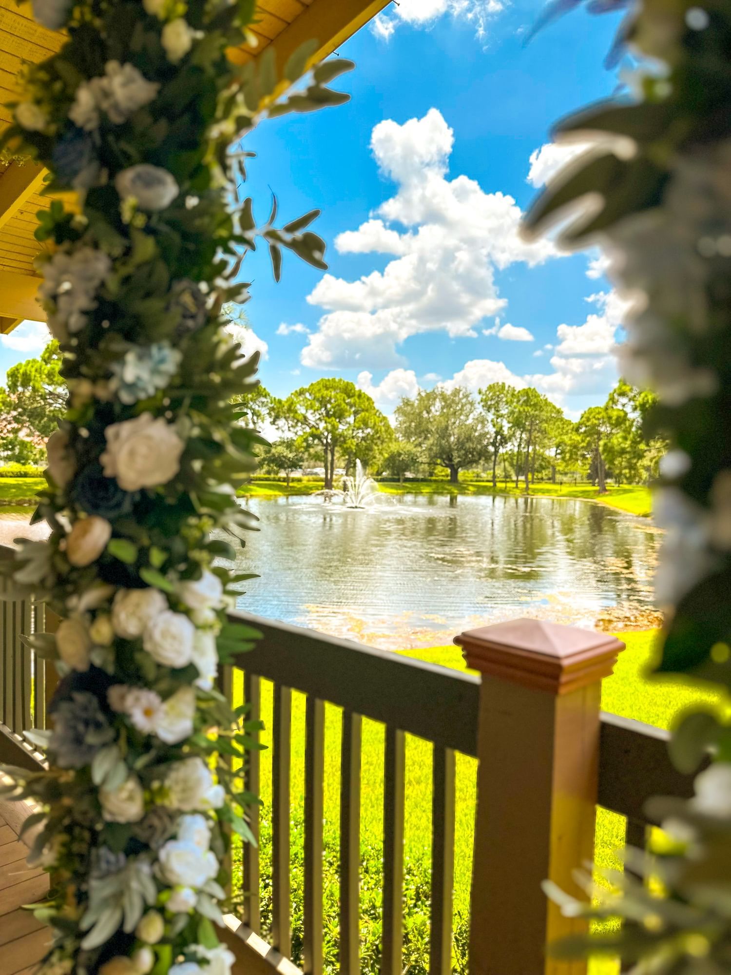 A serene lake view from a balcony with a floral decoration