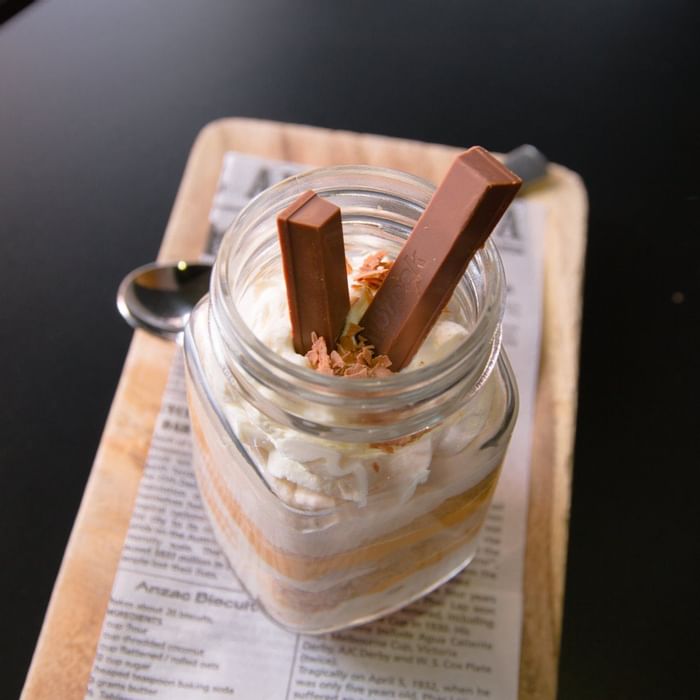 Dessert in a glass jar with cream, chocolate, and two Kit Kat bars, served at Ibis Adelaide