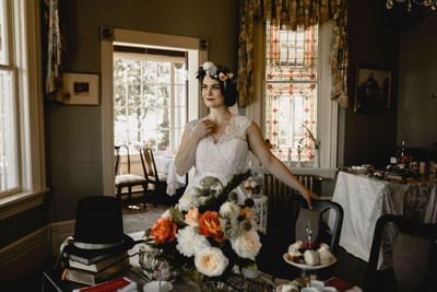 Bride posing by a dining table at Pendray Inn & Tea House