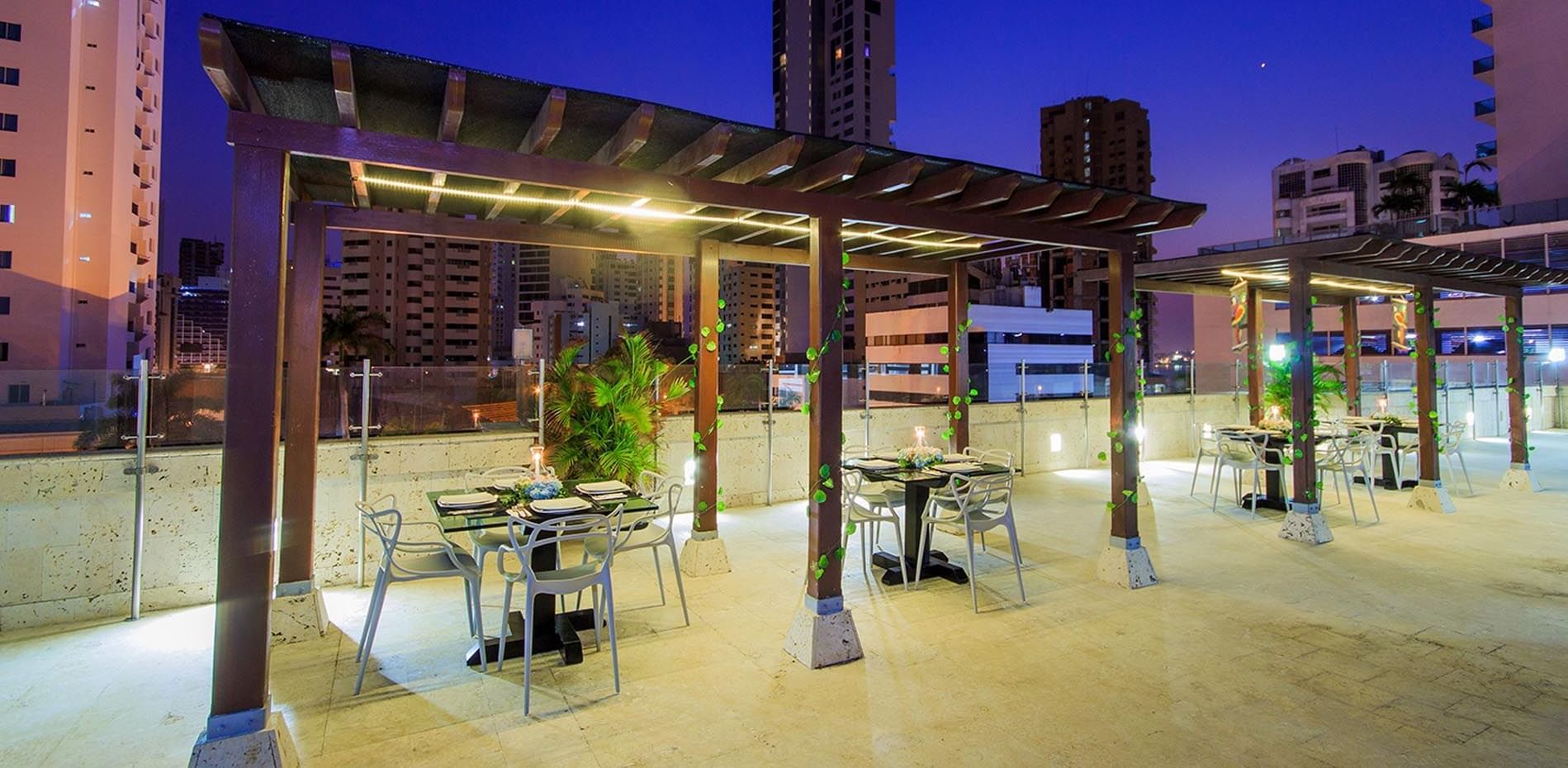 Terrace dining area with city view at GIO Hotel Tama Cartagena