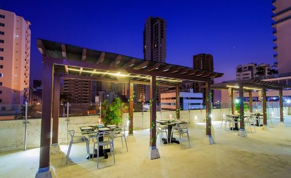 Terrace dining area with city view at GIO Hotel Tama Cartagena