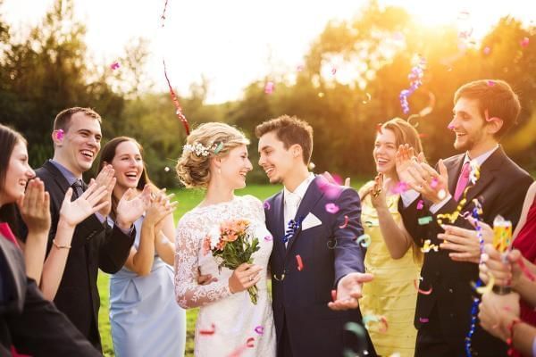 Bride and groom surrounded by their wedding guests