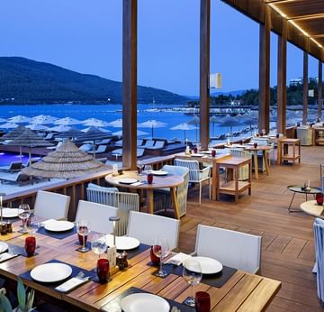 Dining tables set-up with sea View in an evening at Beef Grill Club, Cullinan Belek in Titanic Luxury Collection Bodrum
