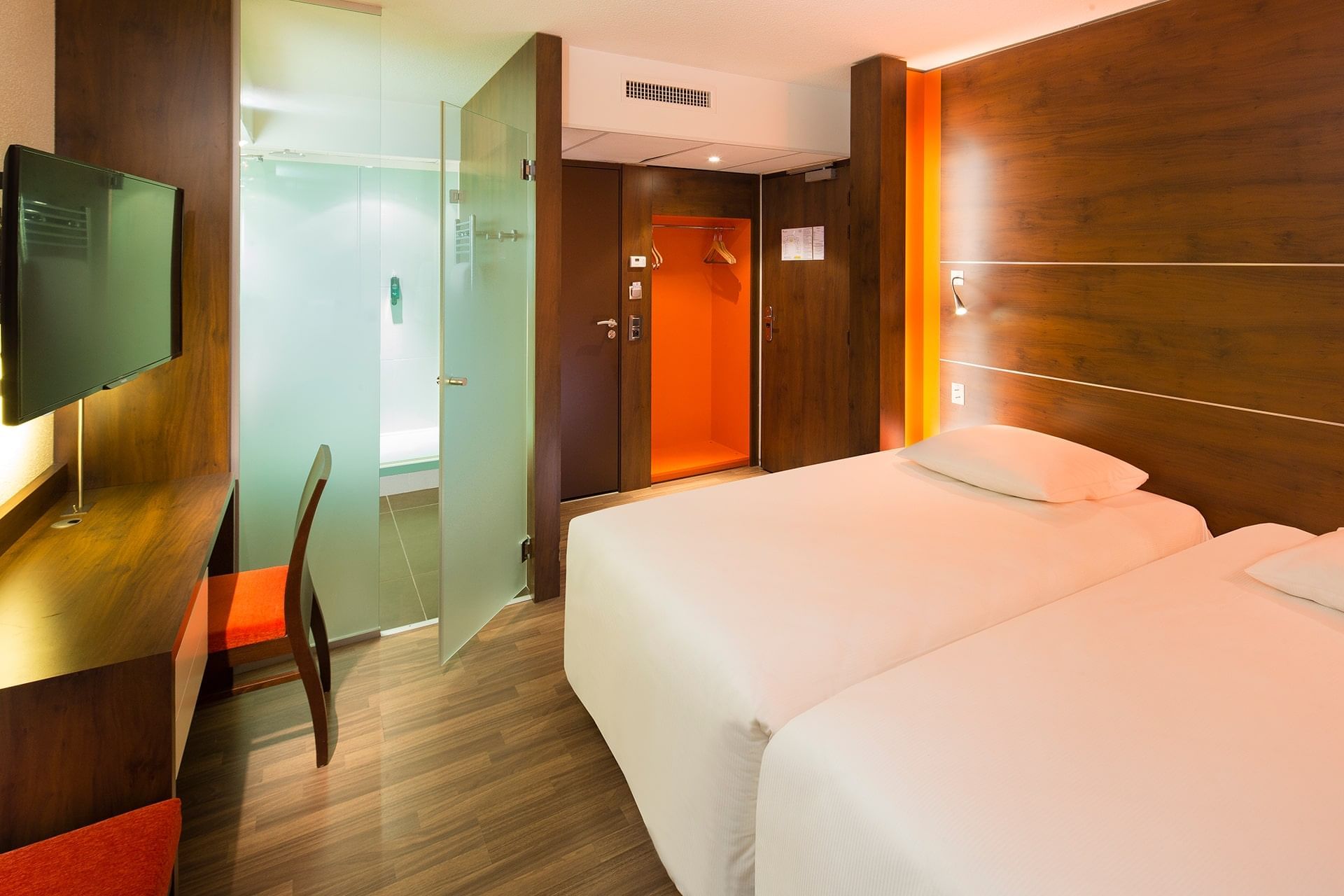 Interior of room with working table & a TV at Oceania Rennes