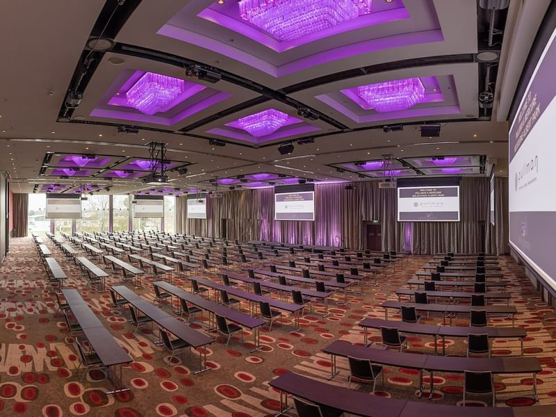 Classroom set-up in Grand Ballroom with screens and carpeted floors at Pullman Albert Park