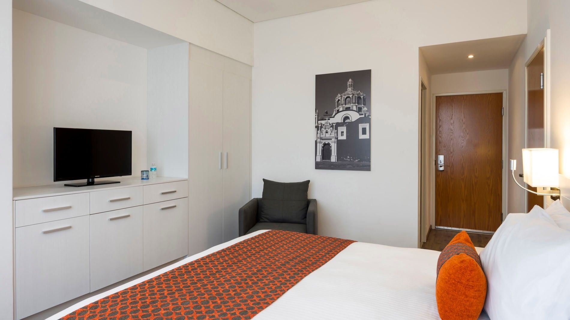Queen Standard bedroom with a black and white architectural art piece on the wall at Camino Real Puebla Angelopolis