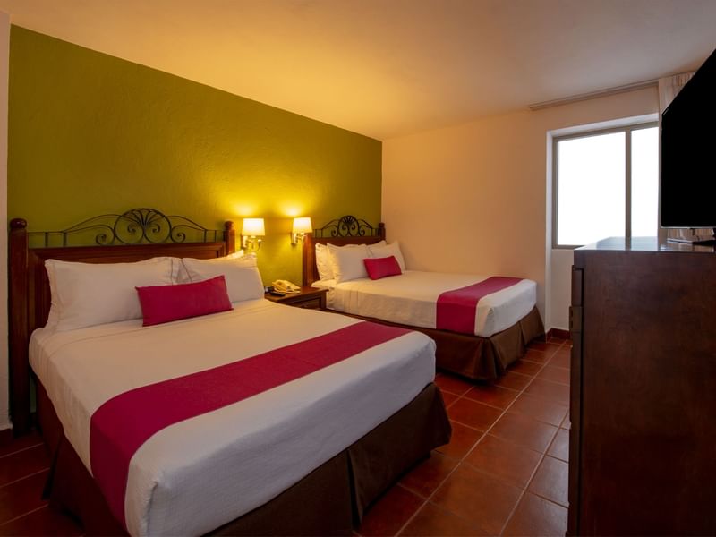 Twin beds & a TV in Presidential Suite at Gamma Hotels