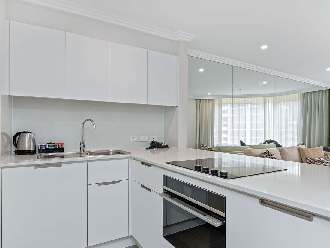 Kitchen facing the living room at Sebel Quay West Suites Sydney