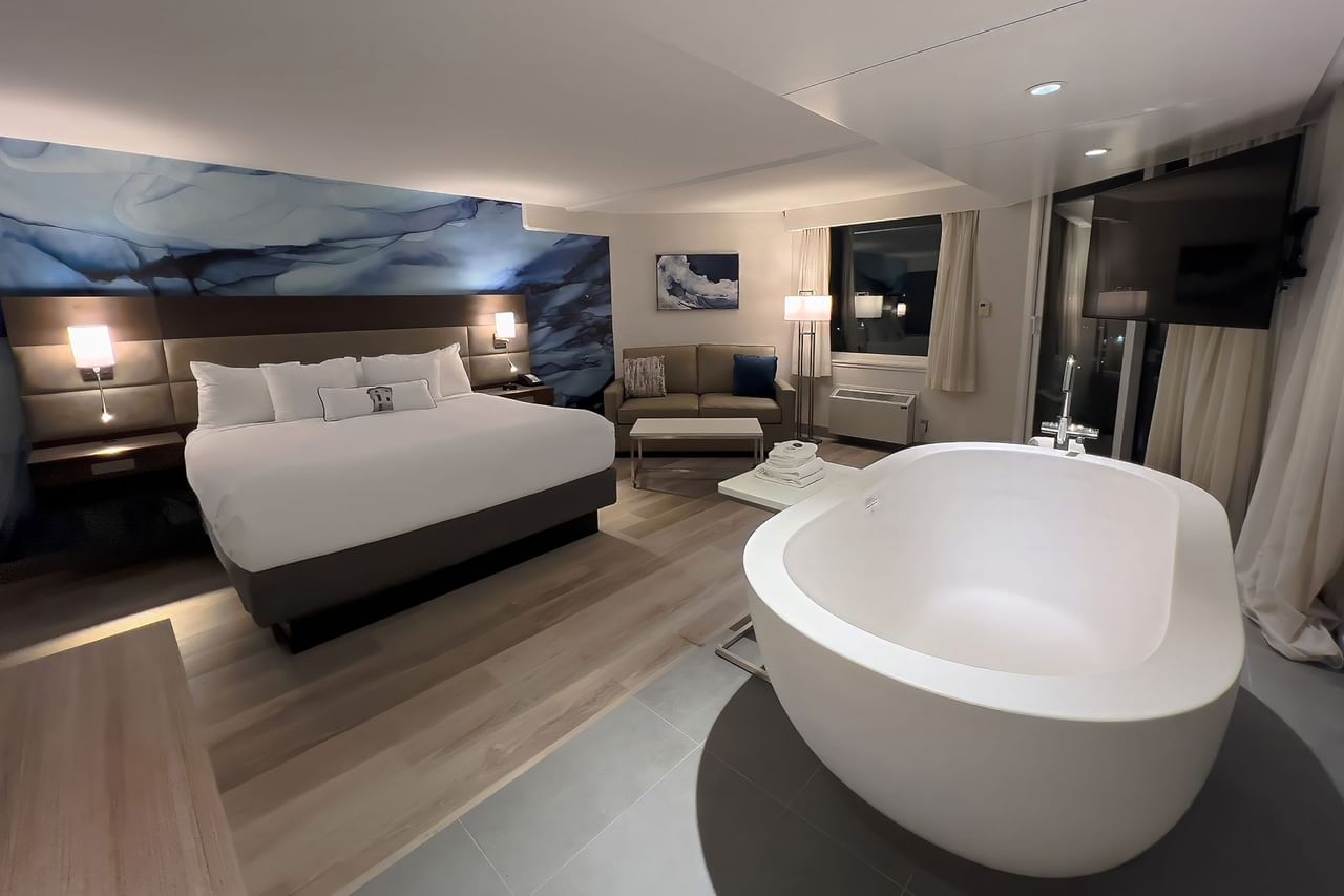 Hotel guestroom with king bed and a soaker tub