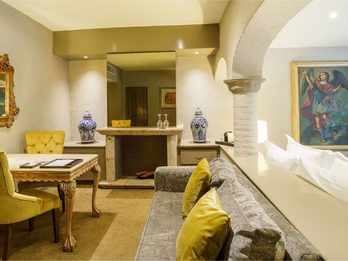 King Master Suite Sophisticated lounge featuring stone arches, velvet seating, and fine artwork at Quinta Real Guadalajara
