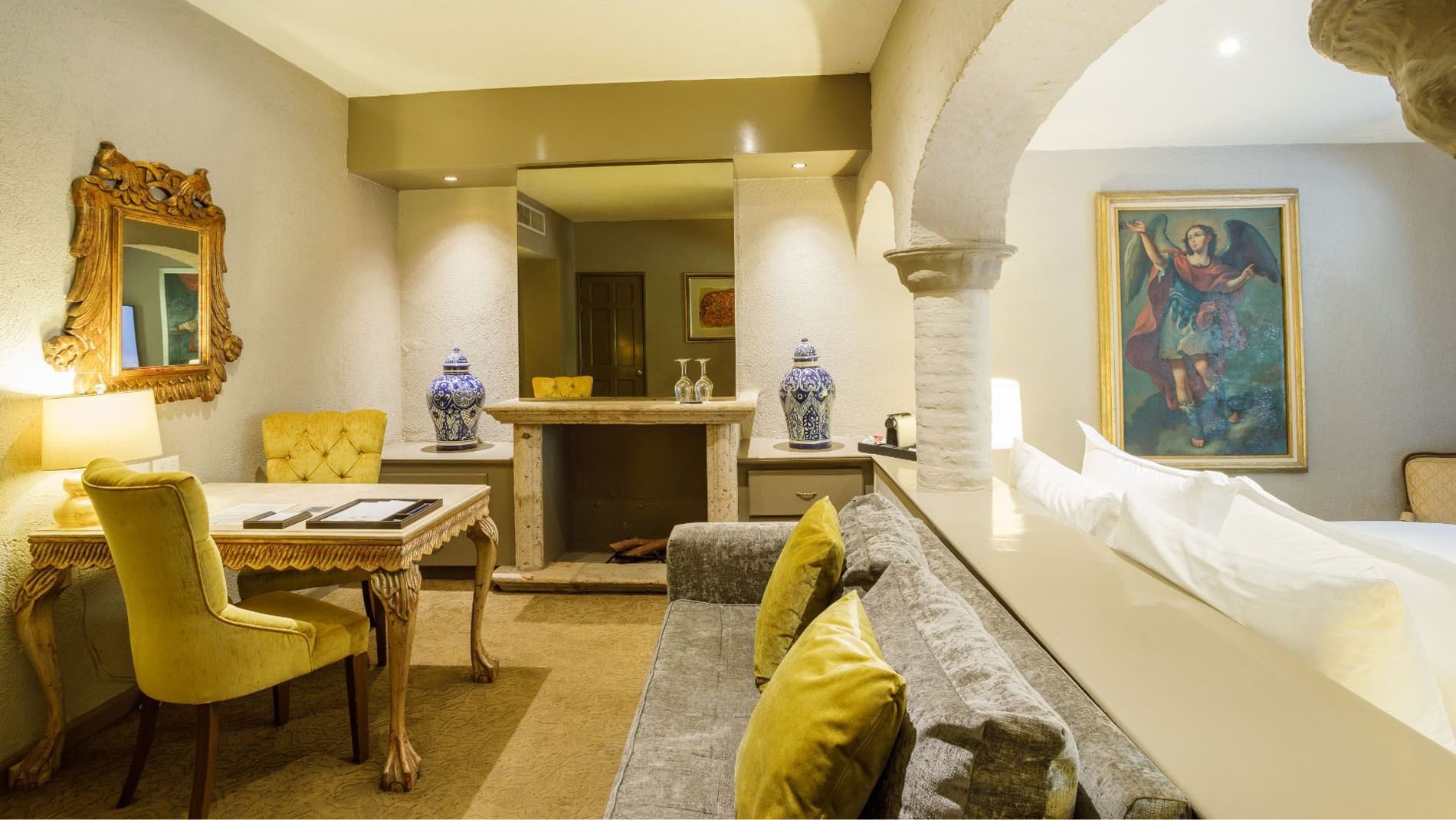 King Master Suite Sophisticated lounge featuring stone arches, velvet seating, and fine artwork at Quinta Real Guadalajara

